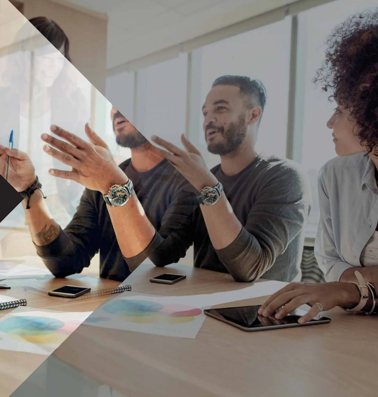 A team in discussion around a table in a bright office